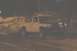 1994 Ford F-150 - A white pickup truck with a black hood is seen on a track, possibly during a race or event.