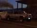 1994 Ford F-150 - A silver pickup truck pulls a trailer, emitting a large plume of dark smoke during a nighttime event.