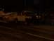 1994 Ford F-150 - A white and black pickup truck is seen with a trailer in the background at night.