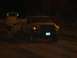 1994 Ford F-150 - A Dodge Ram pickup truck is seen at night, with a tow vehicle behind it. The license plate is visible.