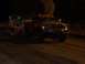 1994 Ford F-150 - A red pickup truck, identified as "BigBadDodge", emits black smoke while towing a trailer in the dark.