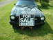 1978 Ford Mustang II - A black 1978 Ford Mustang II is parked on grass with a 'For Sale' sign placed in front of it.