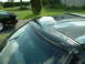 1978 Ford Mustang II - Close-up of a black car's roof and sunroof, with another vehicle partially visible in the background.