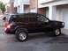 1996 Jeep Grand Cherokee - This Jeep Grand Cherokee has gold rims and appears to be lifted, parked in front of an apartment complex.