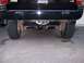 1996 Jeep Grand Cherokee - Rear view of a black 1996 Jeep Grand Cherokee, showing the trailer hitch and V8 badging.