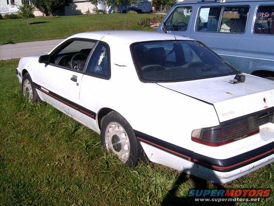 White 1988 Ford Thunderbird 3q-front view parked in grass
