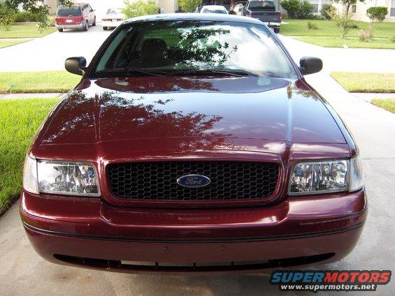 Maroon 2004 Ford Crown Victoria front view with honeycomb grille and Ford emblem