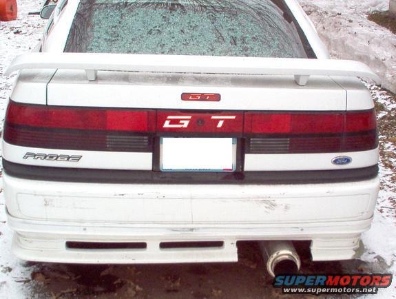 Rear view of a white Ford Probe GT with a spoiler and a custom exhaust tip