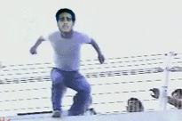 Man in purple shirt and pants in mid-action pose