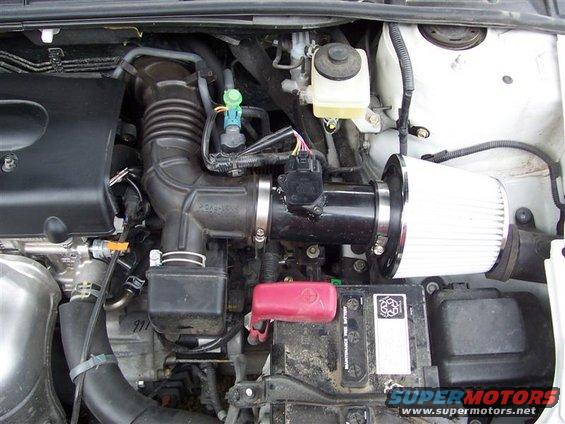 Engine bay with aftermarket air intake and battery
