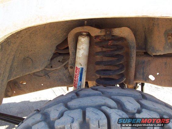 100_0847.jpg The old shock mount on top is in the bucket, and doesn't quite line up with the new lower mount on the radius arms.  I need to fix this at some point.