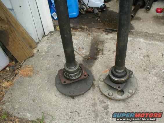 Two axle shafts with hubs on concrete
