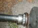 1979 Ford Bronco - Close-up of an axle shaft with a roller bearing and flange, likely a replacement part.