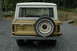 1972 Ford Bronco - The rear of a classic Ford Bronco shows its spare tire and trailer hitch.
