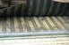 1972 Ford Bronco - Close-up of a vehicle's interior floor, showing corrugated metal and a rubber mat.