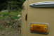 1972 Ford Bronco - Close-up of a tan SUV's side panel, showing damage and a marker light.