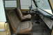 1972 Ford Bronco - Interior view of a 1972 Ford Bronco, showing worn tan seats and dashboard details.