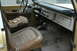 1972 Ford Bronco - The interior of a 1972 Ford Bronco shows its aged condition with torn driver's seat and worn floor mats.