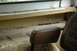 1972 Ford Bronco - The interior of the vehicle shows signs of wear and rust, with a close-up on the passenger seat and armrest.