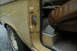 1972 Ford Bronco - Close-up view of a vehicle's interior door jamb and seat, showing signs of wear and rust.