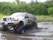 2000 Ford Excursion - This lifted 2000 Ford Excursion navigates through a muddy off-road course.