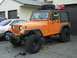 1989 Jeep YJ - This 1989 Jeep YJ is equipped with a roof rack and an auxiliary gas can.