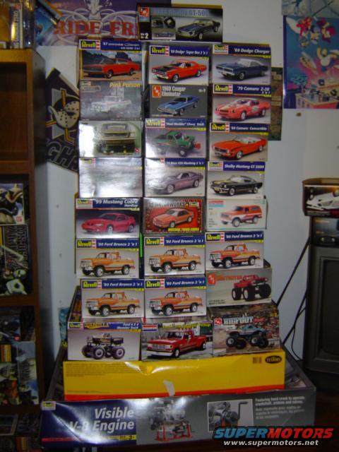 Stack of model car kits including 1979 Ford Bronco and other vehicles