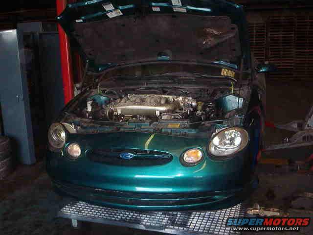 Green 1997 Ford Taurus front view with hood open