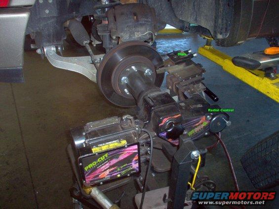 lathe-02.jpg On-car brake lathe.  The motor is turned on, the automatic calibration process finishes, & the cutters are set to the rotor's surfaces.  Then they are positioned at the inner edge of the rotor & tightened 3 counts each.

The depth of cut should be between 0.10 and 0.20 mm (0.004 and 0.008 in). Lighter cuts will cause the bit to heat up and wear faster. Heavier cuts will cause poor brake disc surface finish.