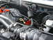 1989 Ford Bronco - Close-up view of the engine bay, showing various hoses, wiring, and engine parts.