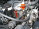 1989 Ford Bronco - Close-up view of an engine bay with various components and hoses visible.