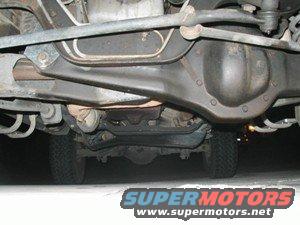 Undercarriage view of vehicle's rear axle and suspension. SuperMotors.net logo visible