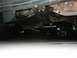 1989 Ford Bronco - Undercarriage view of a vehicle, focusing on the frame and suspension components.
