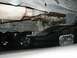 1989 Ford Bronco - The underside of a vehicle is shown, with another vehicle partially visible beneath it.