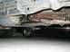 1989 Ford Bronco - The photo shows the underside of a vehicle, focusing on the drivetrain components. Another vehicle is partially visible underneath.