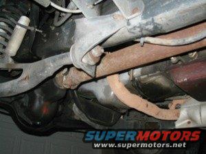 Underside view of vehicle suspension and exhaust system. Supermotors.net logo visible
