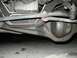 1989 Ford Bronco - A close-up view of the underside of a vehicle, revealing mechanical parts and suspension.