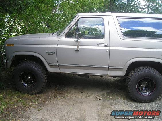 Silver 1984 Ford Bronco side view with black wheels
