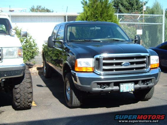 Black 2000 Ford F-250 front view with chrome grille and license plate 327 BDO