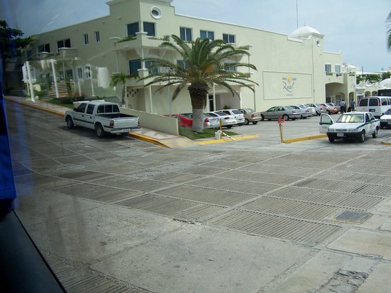 White pickup truck parked on a sloped concrete surface