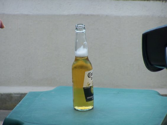 Bottle of Corona Extra beer on a green table