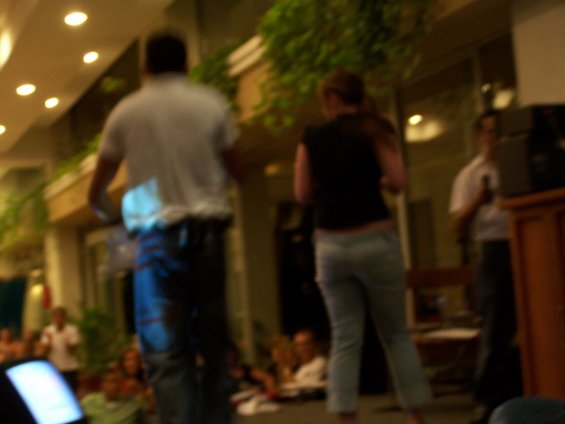 People gathered in a room with plants and lights