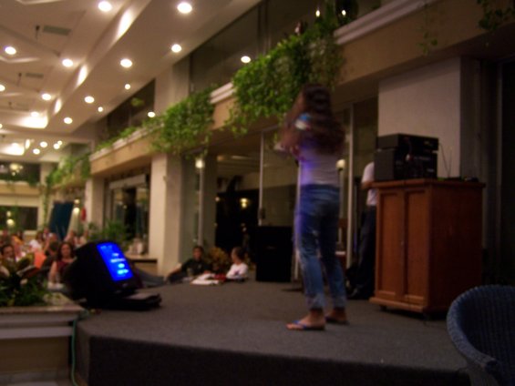 People on a stage with a monitor and sound equipment