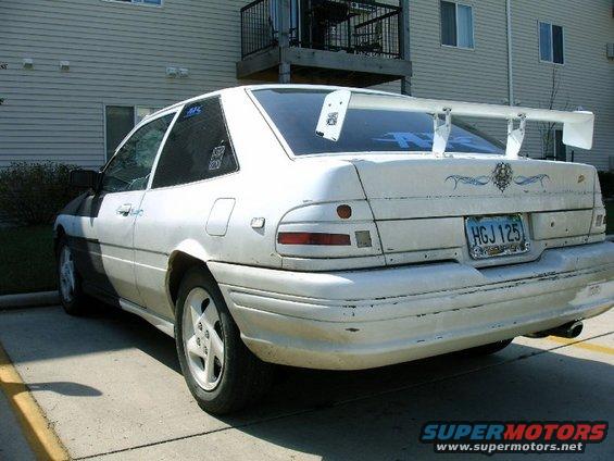 1992 Ford Probe with a large white rear spoiler and custom decals on the trunk