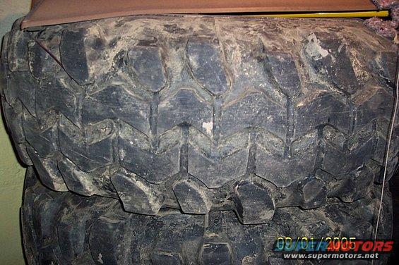 stack of used off-road tires, one on top of another