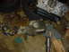 1986 Ford Mustang - Engine and transmission components, along with tires, are laid out on a cluttered garage floor.