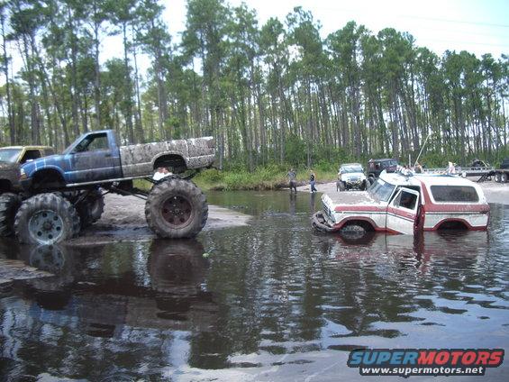 1978 Ford Bronco submerged in water, 3q-front view, red and white