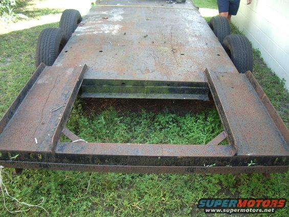 Rusty trailer with four wheels and ramps