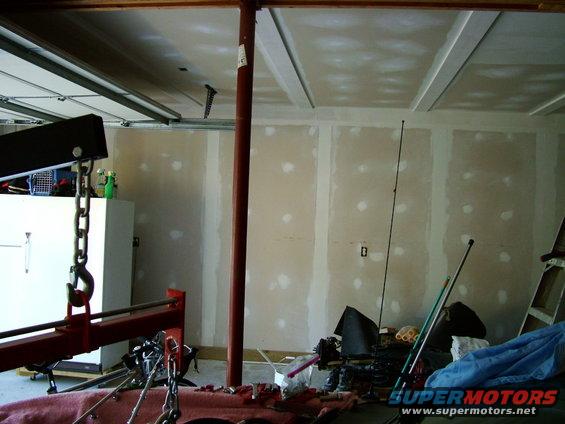 Garage scene with engine hoist and unfinished walls