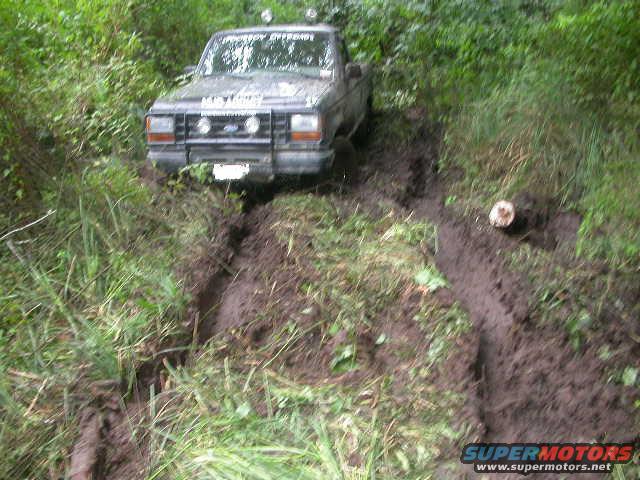 1992 Ford Ranger stuck in a muddy ditch, front 3/4 view